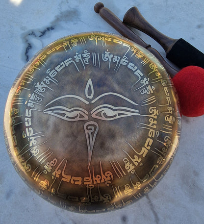 Tibetan singing bowl with engraved designs on a marble surface