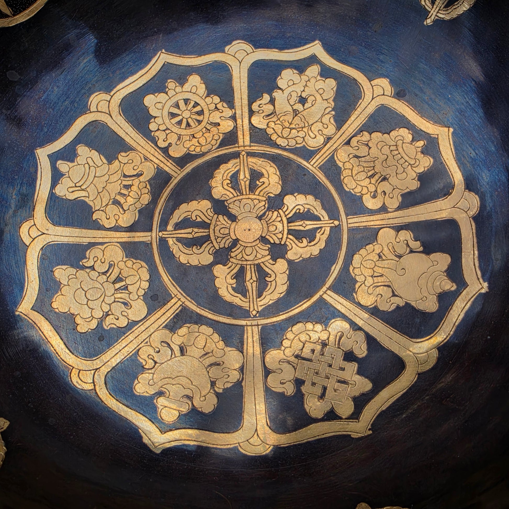 The Eight Auspicious Symbols surrounding the Double Dorje represent protection, wisdom, abundance and spiritual awakening